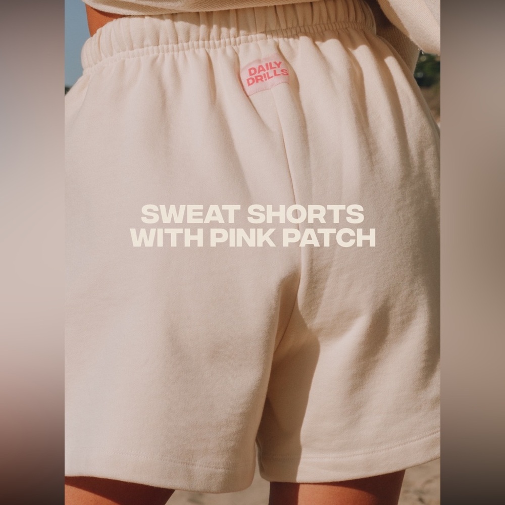 Daily Drills Sweat Shorts in Sand with Pink Patch